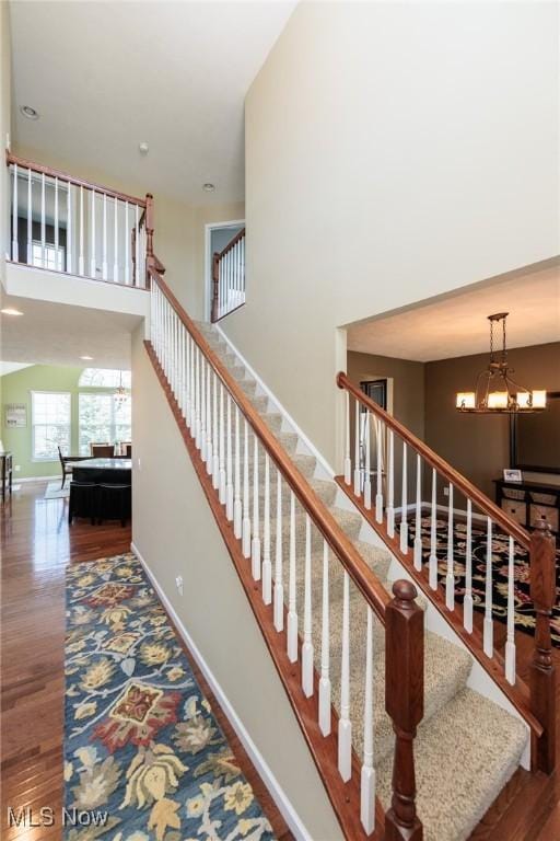 3139 Junior Pkwy, Brunswick, OH 44212 - staircase with a towering ceiling, wood finished floors, and a chandelier