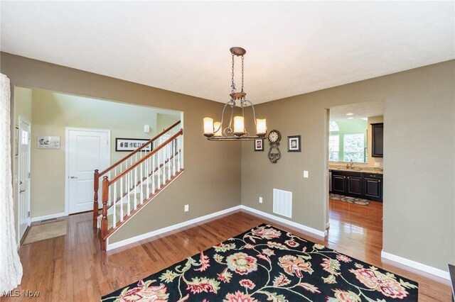 3139 Junior Pkwy, Brunswick, OH 44212 - entryway featuring stairway, light wood finished floors, and a chandelier