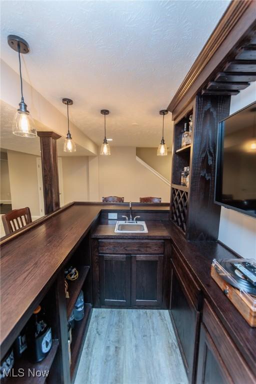 3139 Junior Pkwy, Brunswick, OH 44212 - indoor wet bar with light wood-style flooring and hanging light fixtures
