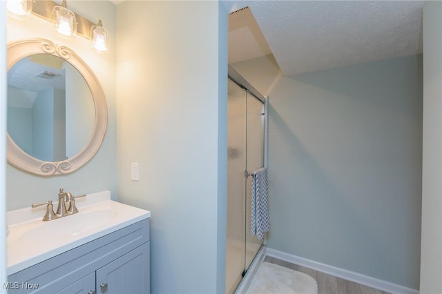 3139 Junior Pkwy, Brunswick, OH 44212 - full bathroom with a stall shower, vanity, wood finished floors, and a textured ceiling