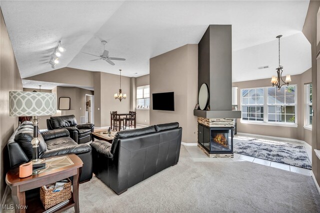 254 Vista Cir, North Olmsted, OH 44070 - living area featuring a chandelier, vaulted ceiling, rail lighting, a ceiling fan, and a multi sided fireplace
