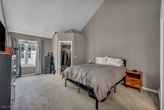254 Vista Cir, North Olmsted, OH 44070 - bedroom featuring vaulted ceiling, light colored carpet, a walk in closet, and a closet