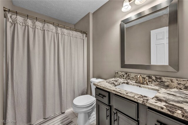 254 Vista Cir, North Olmsted, OH 44070 - bathroom with vanity, a textured ceiling, and a shower with curtain