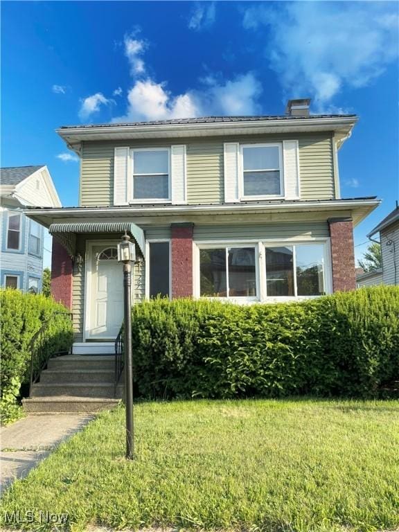707 Jefferson St, Toronto, OH 43964 - view of front of house featuring a front yard and a chimney