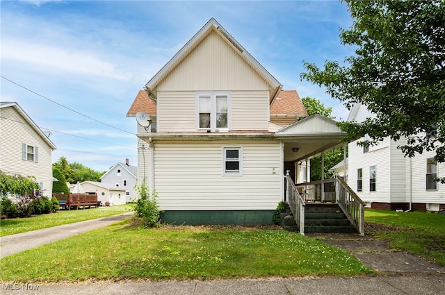238 Whitney St, Conneaut, OH 44030 - view of front facade with a front lawn, a porch, and board and batten siding