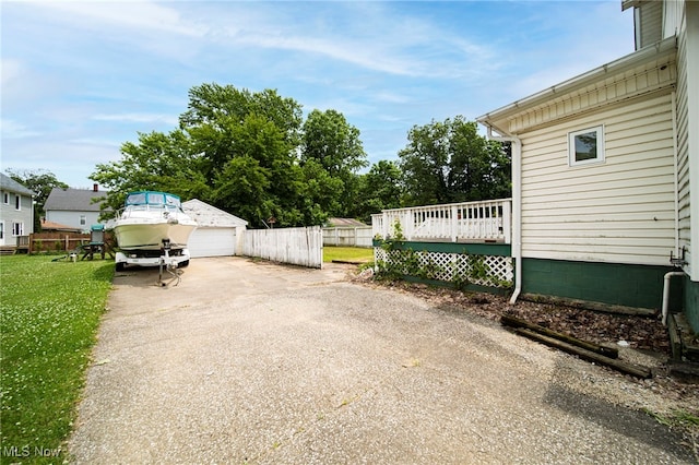 238 Whitney St, Conneaut, OH 44030 - view of patio / terrace featuring a wooden deck, a detached garage, and driveway