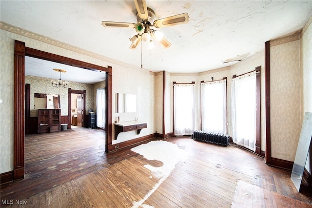 238 Whitney St, Conneaut, OH 44030 - unfurnished room featuring wallpapered walls, wood-type flooring, radiator heating unit, ceiling fan, and a chandelier
