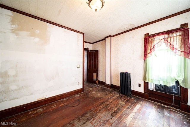238 Whitney St, Conneaut, OH 44030 - spare room featuring radiator, hardwood / wood-style floors, ornamental molding, and plenty of natural light