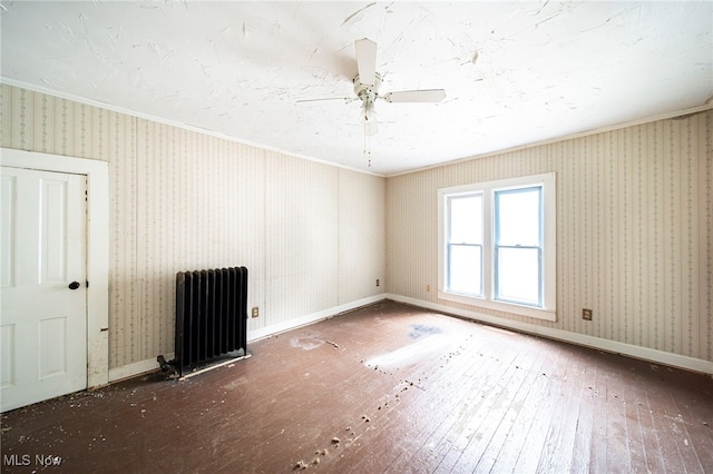 238 Whitney St, Conneaut, OH 44030 - empty room featuring radiator, ornamental molding, hardwood / wood-style flooring, and ceiling fan