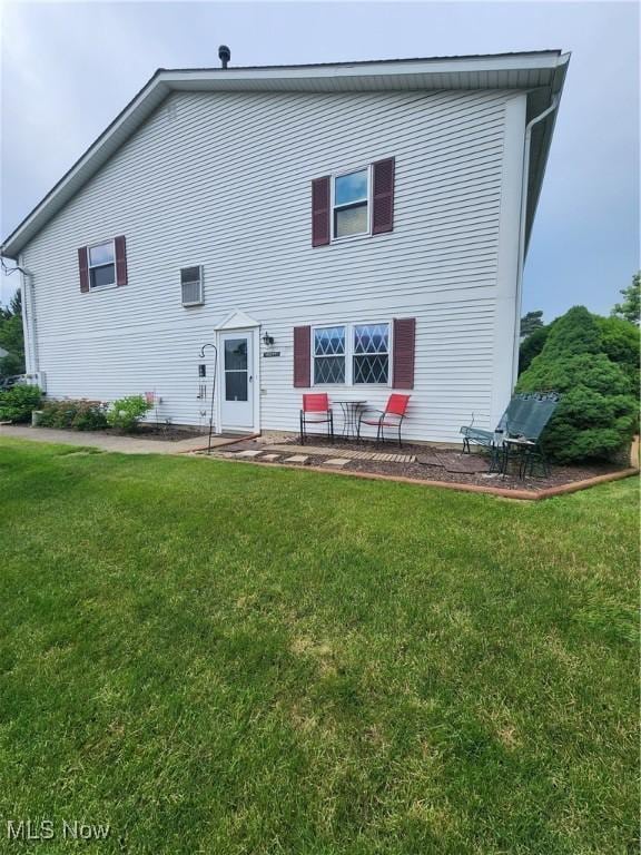 4211 Dennis Ln, Brunswick, OH 44212 - rear view of house featuring a yard and a patio area