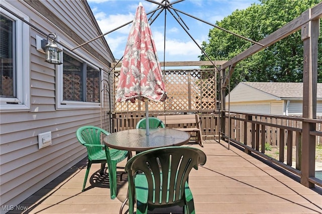 4843 Summer Ln, Brooklyn, OH 44144 - wooden deck with outdoor dining area and an outbuilding