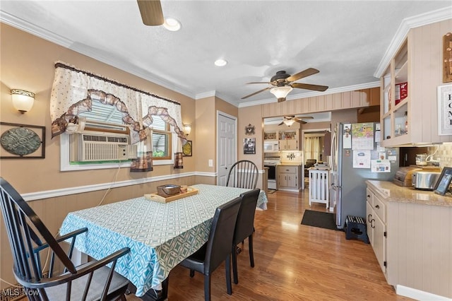 4843 Summer Ln, Brooklyn, OH 44144 - dining space with a ceiling fan, light wood-style flooring, crown molding, and wainscoting