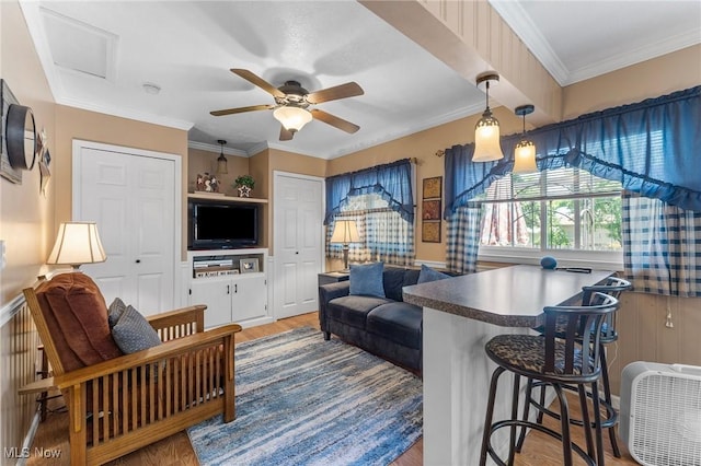 4843 Summer Ln, Brooklyn, OH 44144 - living room featuring a ceiling fan, wood finished floors, and ornamental molding