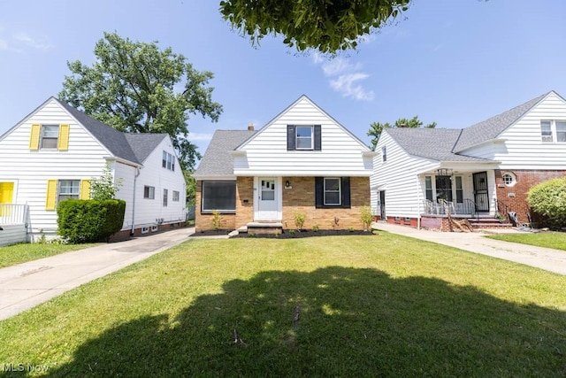 4033 Stonehaven Rd, South Euclid, OH 44121 - bungalow with brick siding, a front lawn, and covered porch