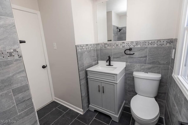 4033 Stonehaven Rd, South Euclid, OH 44121 - full bath featuring tile walls, vanity, tile patterned floors, a wainscoted wall, and a shower