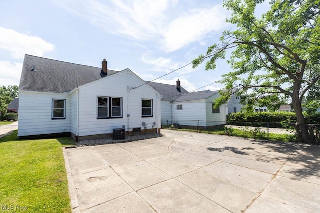 4033 Stonehaven Rd, South Euclid, OH 44121 - back of property featuring roof with shingles, a chimney, and a patio area