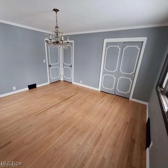 726 Orlo Ln, Boardman, OH 44512 - unfurnished dining area featuring a chandelier, light wood-style flooring, and ornamental molding