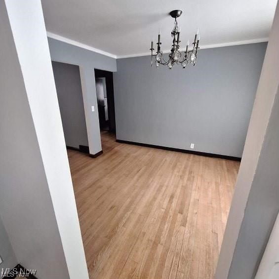 726 Orlo Ln, Boardman, OH 44512 - unfurnished room with ornamental molding, wood finished floors, and a chandelier