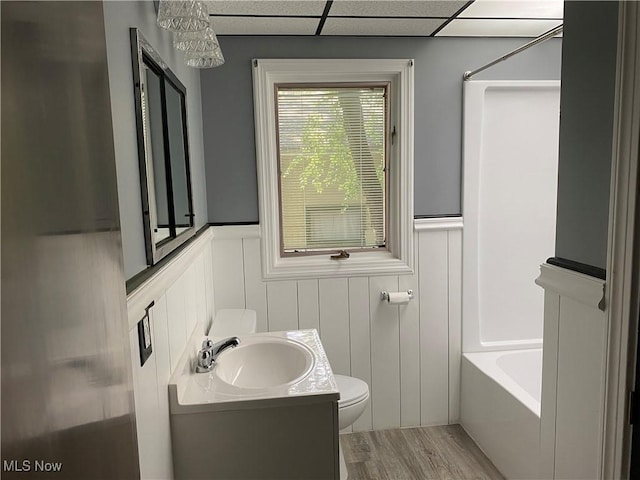 726 Orlo Ln, Boardman, OH 44512 - full bathroom featuring vanity, a wainscoted wall, wood finished floors, and a decorative wall