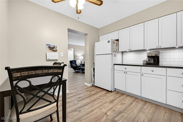 4183 Columbia Rd, North Olmsted, OH 44070 - kitchen with freestanding refrigerator, light wood finished floors, dark countertops, ceiling fan, and tasteful backsplash
