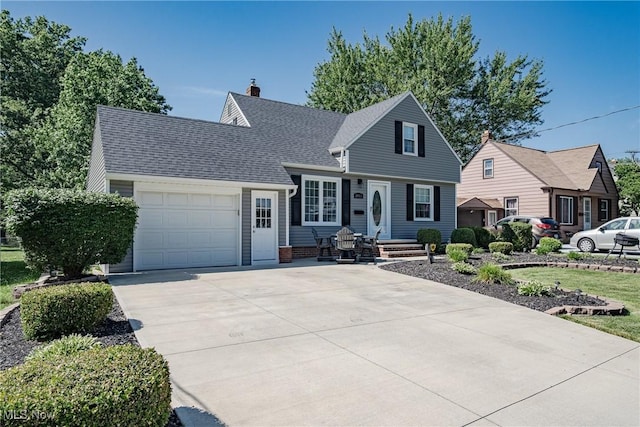 29511 Grand Blvd, Wickliffe, OH 44092 - view of front facade with an attached garage, concrete driveway, a chimney, and roof with shingles