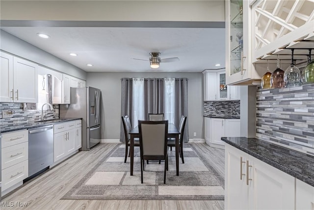 29511 Grand Blvd, Wickliffe, OH 44092 - kitchen with appliances with stainless steel finishes, backsplash, light wood-type flooring, white cabinetry, and recessed lighting