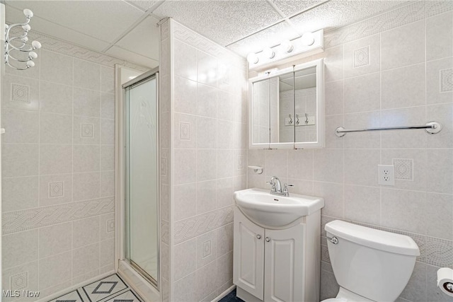 29511 Grand Blvd, Wickliffe, OH 44092 - bathroom with tile walls, vanity, a shower stall, and tile patterned floors