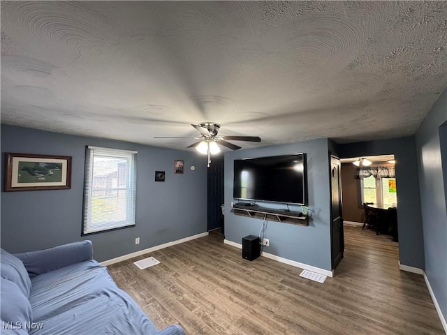 10097 March Rd NE, East Rochester, OH 44625 - living room featuring ceiling fan, wood finished floors, a textured ceiling, and a chandelier