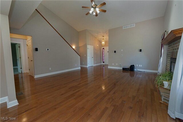9812 Creekside Way, Streetsboro, OH 44241 - unfurnished living room featuring ceiling fan, wood finished floors, a brick fireplace, and vaulted ceiling