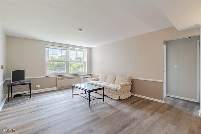 19201 Van Aken Blvd Unit 211, Shaker Heights, OH 44122 - living area with radiator, wood finished floors, and a wall unit AC