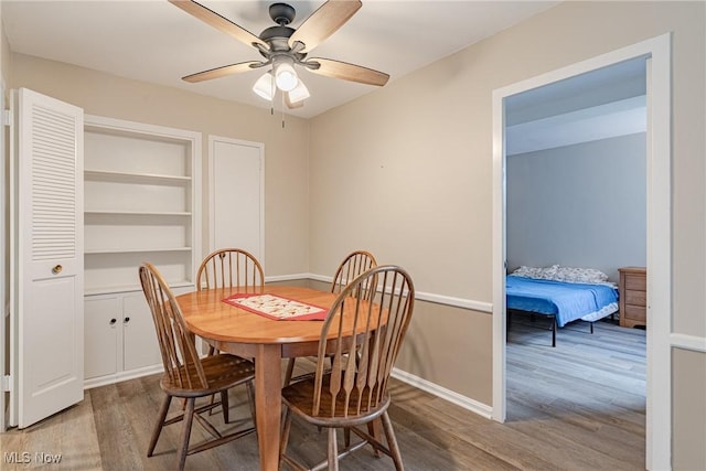 19201 Van Aken Blvd Unit 211, Shaker Heights, OH 44122 - dining room with wood finished floors, a ceiling fan, and built in shelves