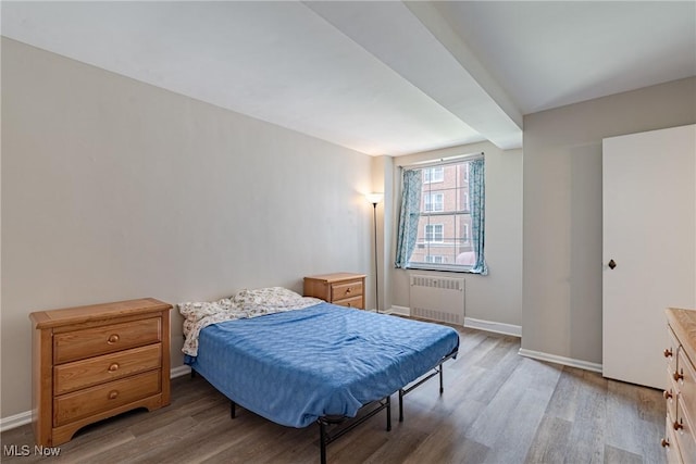 19201 Van Aken Blvd Unit 211, Shaker Heights, OH 44122 - bedroom featuring radiator heating unit and light wood-type flooring