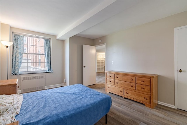 19201 Van Aken Blvd Unit 211, Shaker Heights, OH 44122 - bedroom with radiator heating unit and wood finished floors