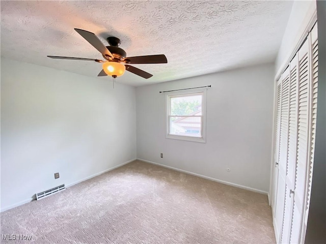 123 Prentiss St, Munroe Falls, OH 44262 - unfurnished bedroom featuring carpet, a closet, a textured ceiling, and ceiling fan