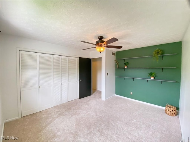 123 Prentiss St, Munroe Falls, OH 44262 - unfurnished bedroom featuring carpet flooring, a closet, ceiling fan, and a textured ceiling
