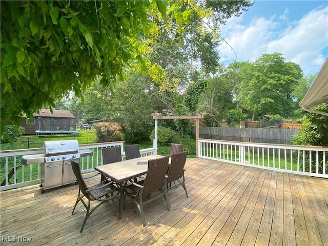 123 Prentiss St, Munroe Falls, OH 44262 - deck featuring a trampoline, area for grilling, outdoor dining area, and a fenced backyard