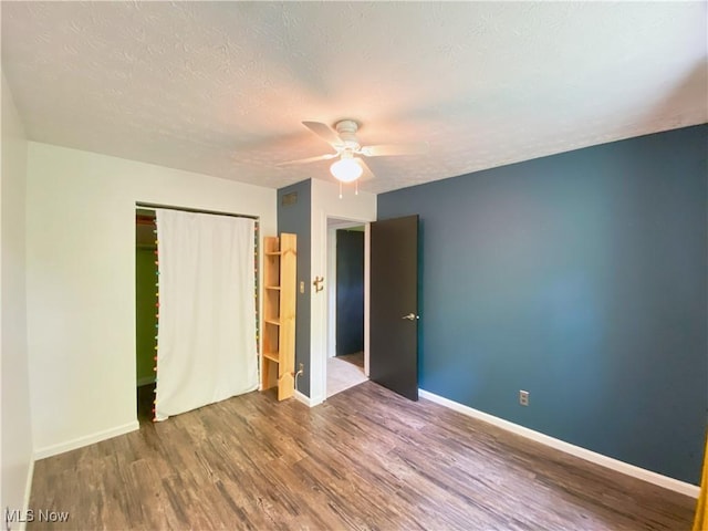 123 Prentiss St, Munroe Falls, OH 44262 - unfurnished bedroom with wood finished floors, a closet, a textured ceiling, and ceiling fan