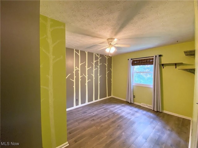 123 Prentiss St, Munroe Falls, OH 44262 - unfurnished room with a textured ceiling, a ceiling fan, and wood finished floors