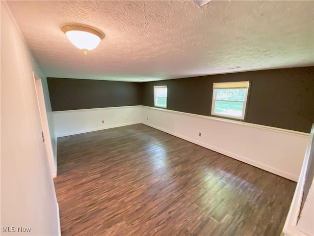 123 Prentiss St, Munroe Falls, OH 44262 - unfurnished room featuring a textured ceiling and dark wood-style floors