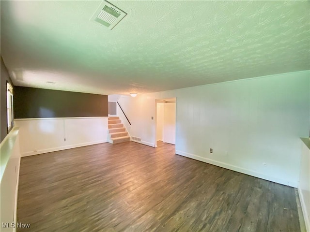123 Prentiss St, Munroe Falls, OH 44262 - unfurnished room with a textured ceiling, dark wood-style floors, and stairs