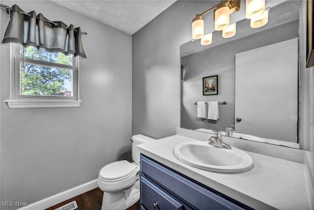 567 Westminster Cir, Akron, OH 44319 - half bathroom featuring wood finished floors, a textured ceiling, and vanity