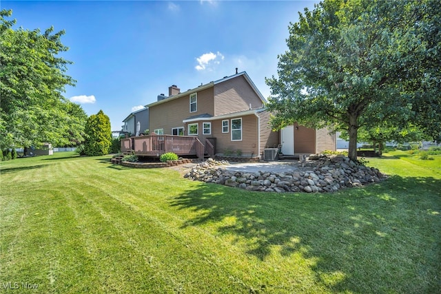 567 Westminster Cir, Akron, OH 44319 - back of house featuring a wooden deck, a yard, a chimney, and a patio