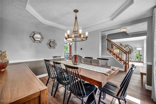 567 Westminster Cir, Akron, OH 44319 - dining area with a textured ceiling, a tray ceiling, wood finished floors, a chandelier, and stairway