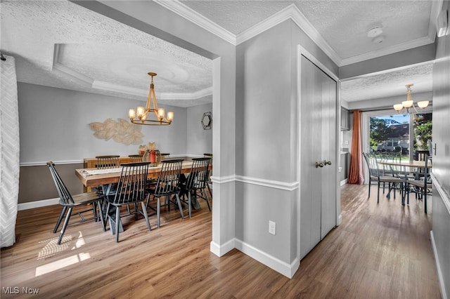 567 Westminster Cir, Akron, OH 44319 - dining area featuring a chandelier, a textured ceiling, and wood finished floors