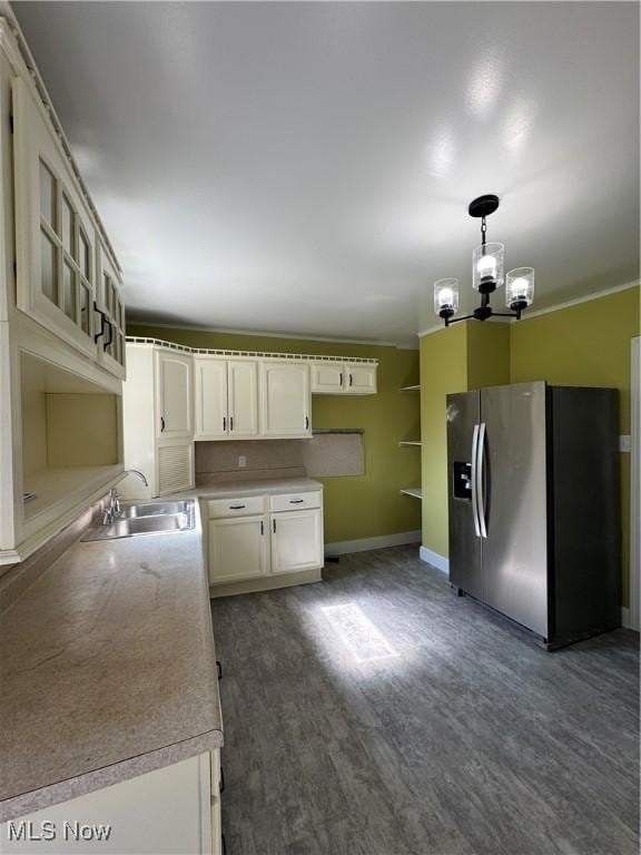 358 N 8th St, Coshocton, OH 43812 - kitchen with stainless steel fridge with ice dispenser, a chandelier, dark wood finished floors, glass insert cabinets, and white cabinetry