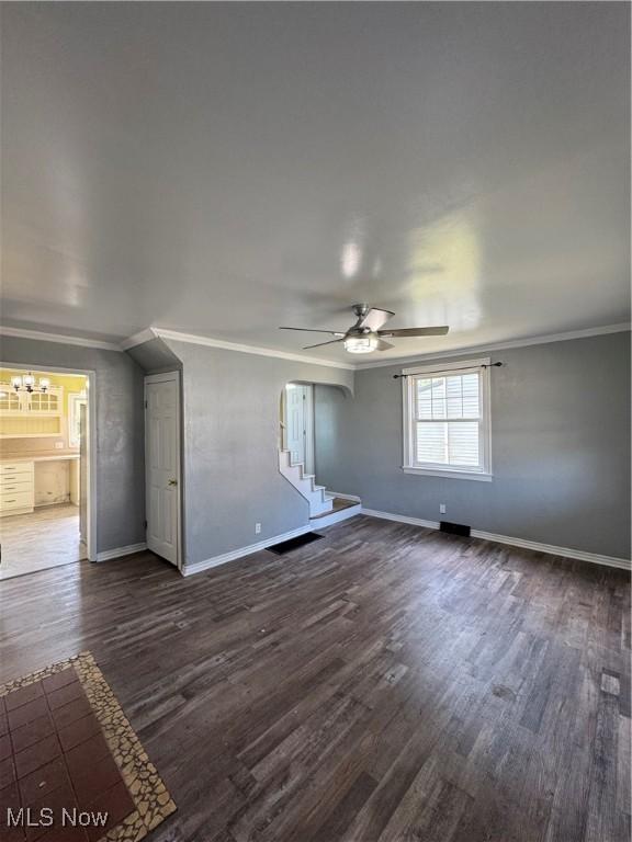 358 N 8th St, Coshocton, OH 43812 - unfurnished room with ornamental molding, ceiling fan, dark wood-type flooring, and stairway