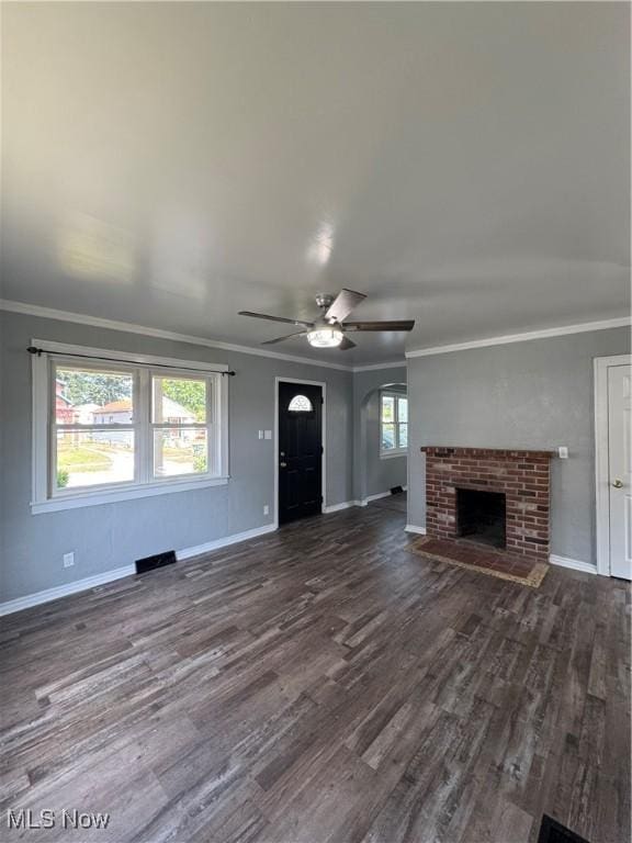 358 N 8th St, Coshocton, OH 43812 - unfurnished living room with dark wood-style floors, a fireplace, ceiling fan, ornamental molding, and arched walkways