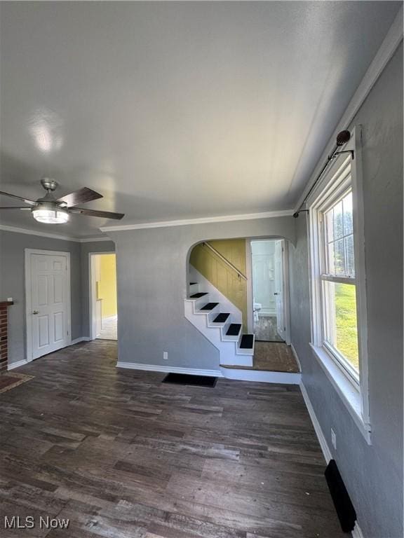 358 N 8th St, Coshocton, OH 43812 - unfurnished living room with stairway, wood finished floors, crown molding, a ceiling fan, and arched walkways