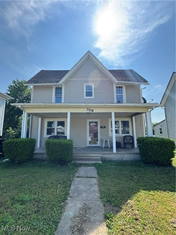 358 N 8th St, Coshocton, OH 43812 - view of front of house featuring a front yard, a porch, and a shingled roof