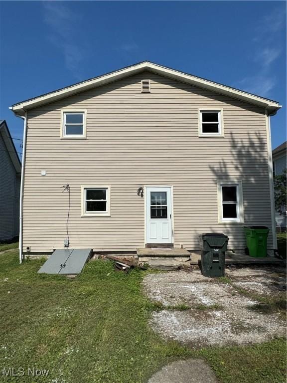358 N 8th St, Coshocton, OH 43812 - back of house featuring a lawn